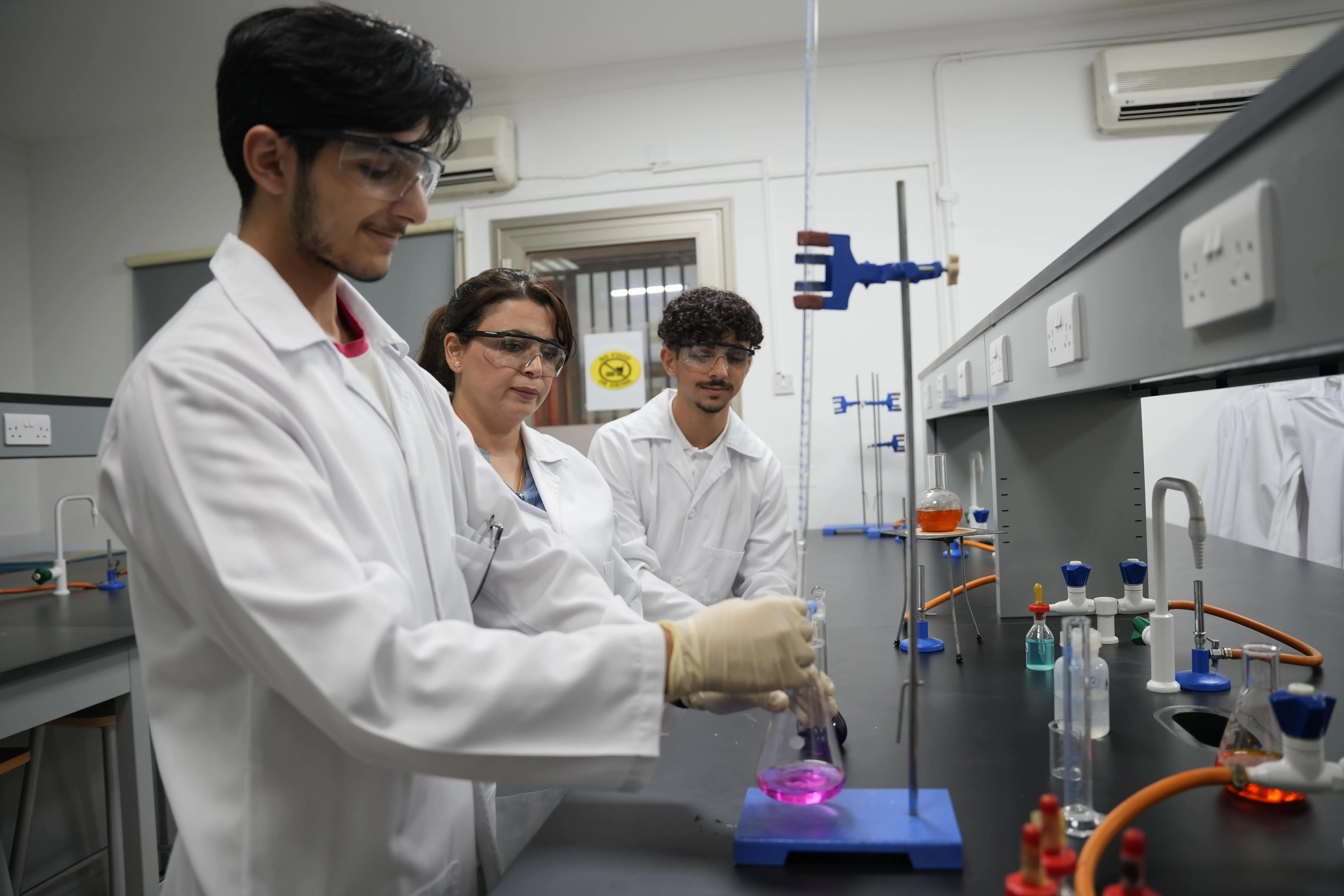 Students working on a physics lab experiment at CBS Kuwait
